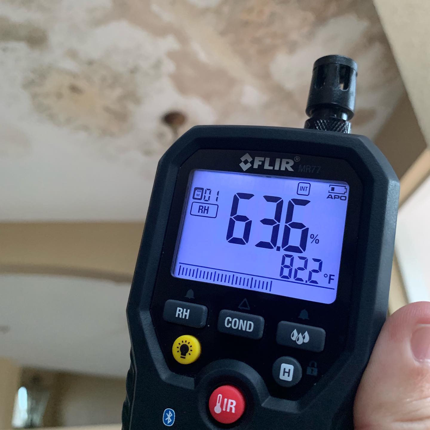 Moisture reading at a stained ceiling
